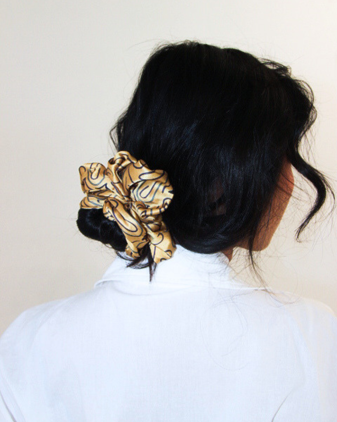Woman with deep yellow scrunchy in hair