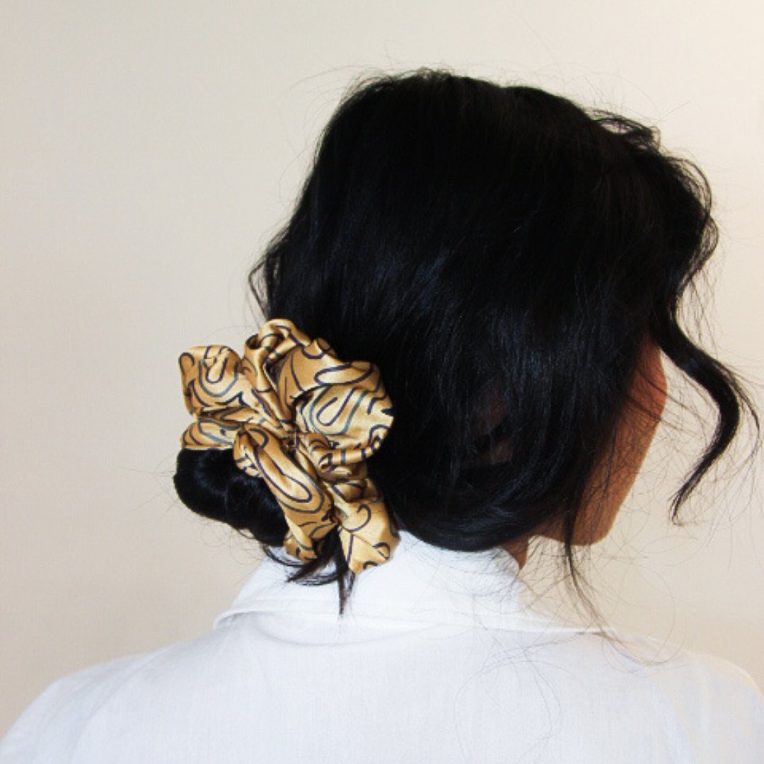 Woman with deep yellow scrunchy in hair
