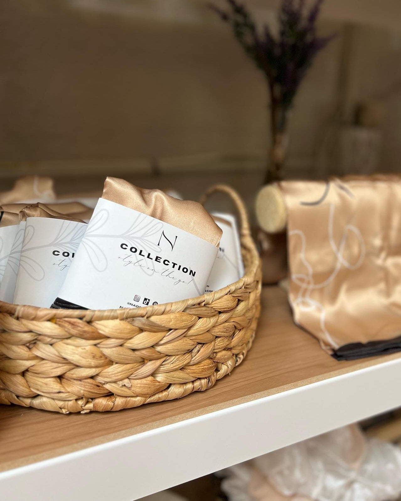 Wicker basket with coffee bags on a wooden surface, blurred background