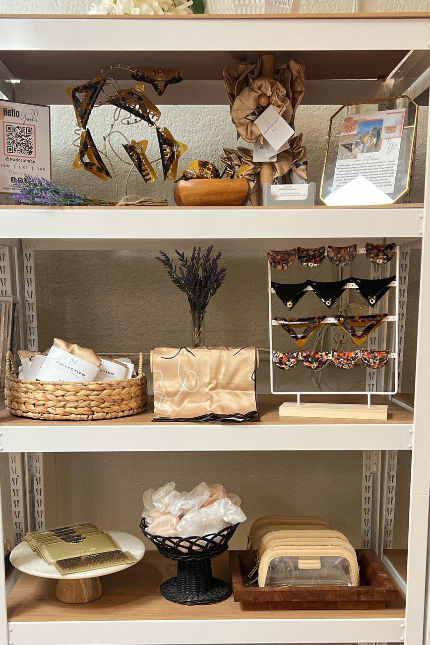 Shelves with various items including bags, boxes, and decorative objects in a store setting.
