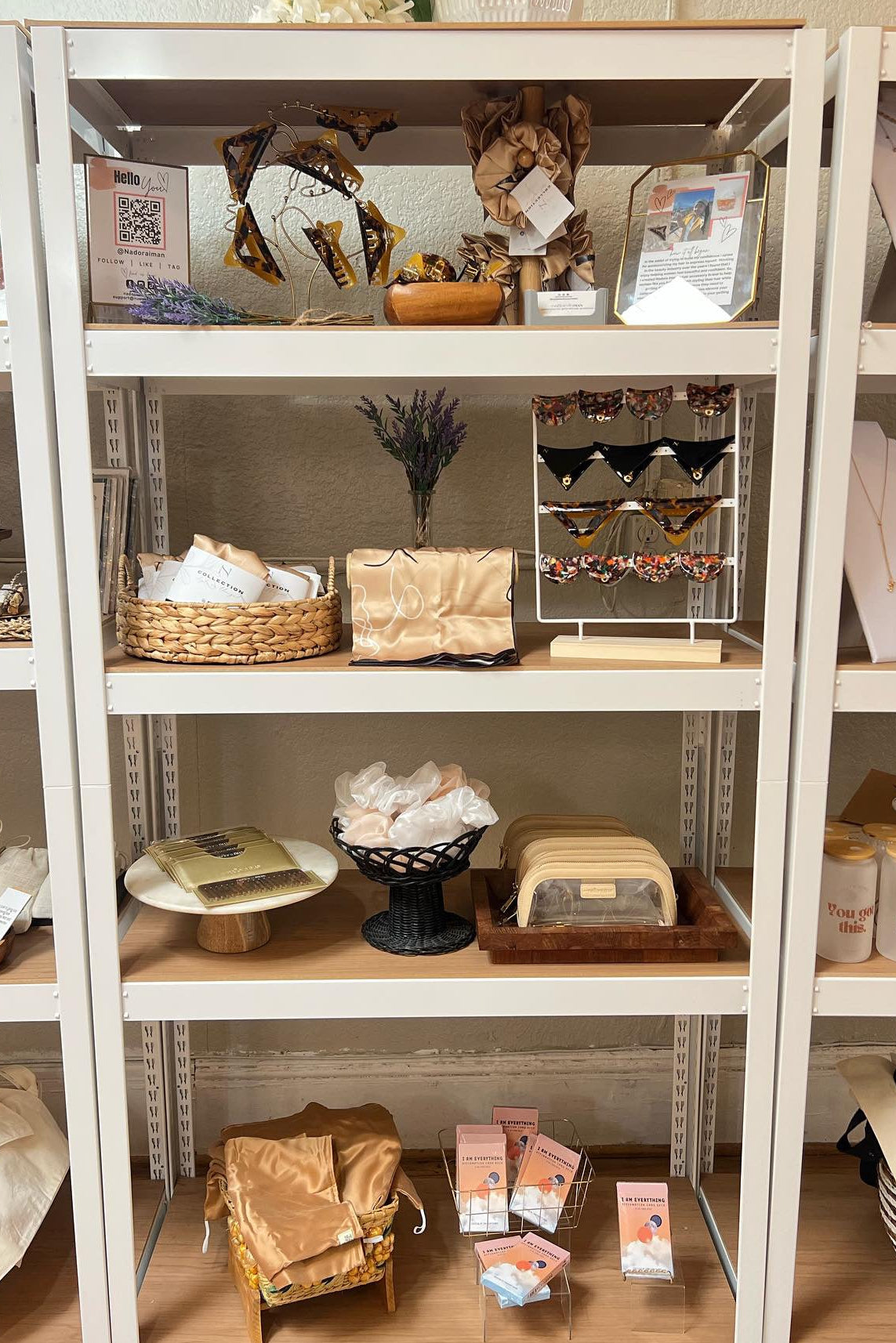 Shelves with various items including bags, boxes, and decorative objects in a store setting.